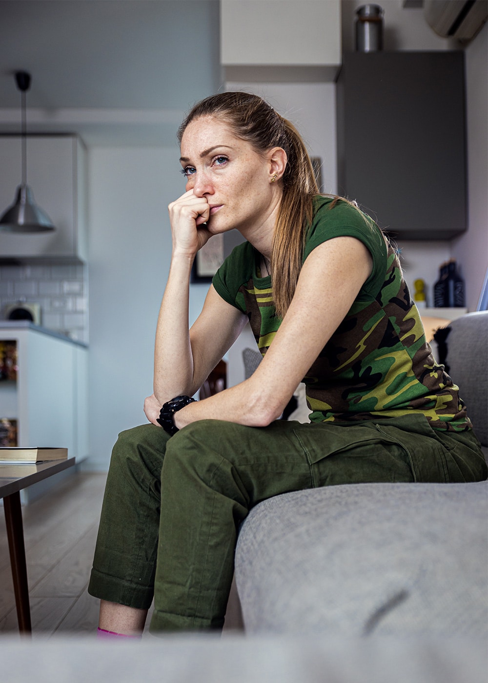 A tired parent at home, taking a quiet moment